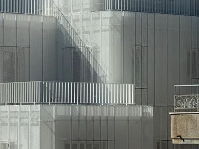 Arid Wraps a 1951 Athens Corner Building in a Perforated Aluminum Veil That Breathes