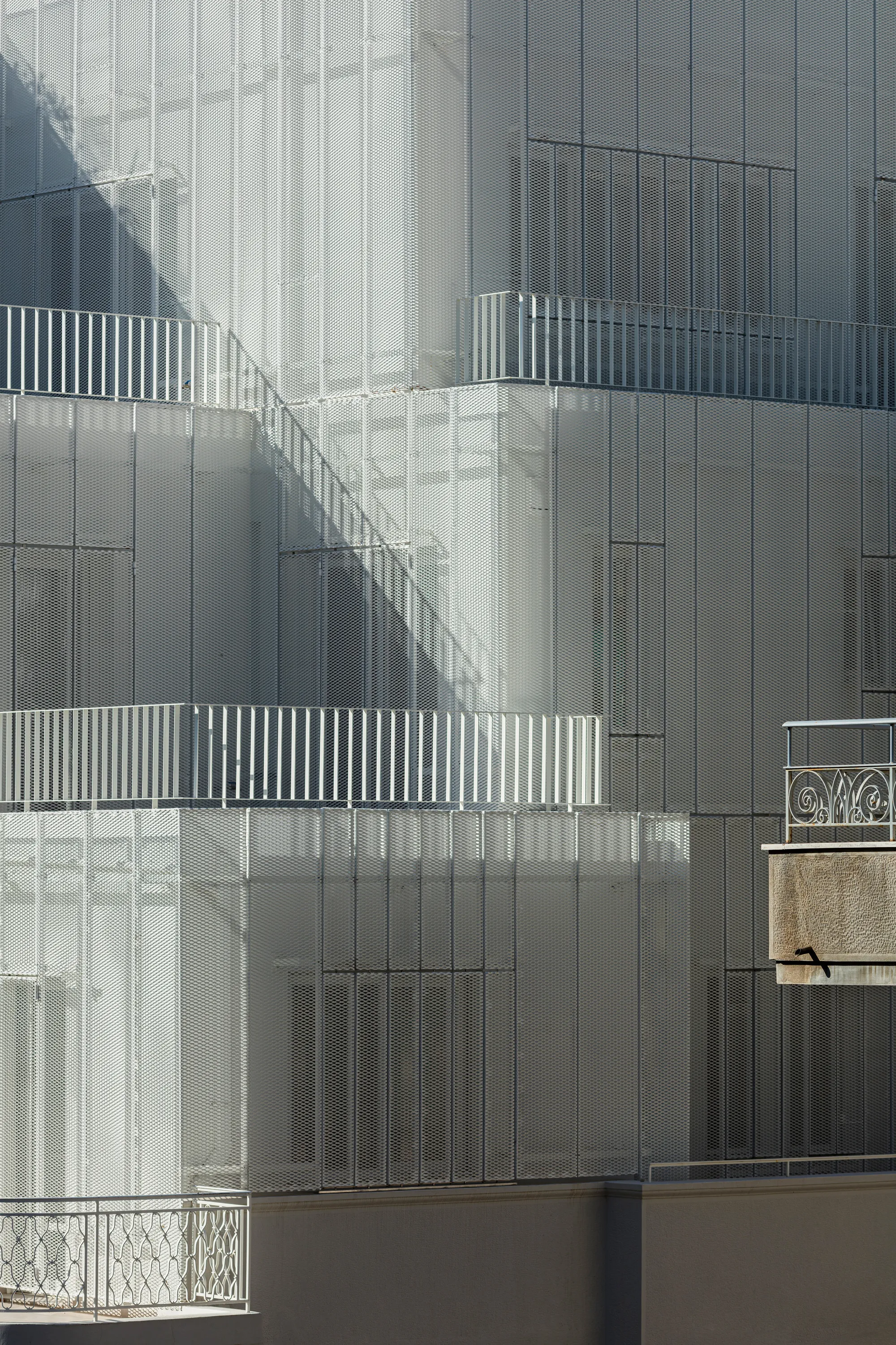 Arid Wraps a 1951 Athens Corner Building in a Perforated Aluminum Veil That Breathes