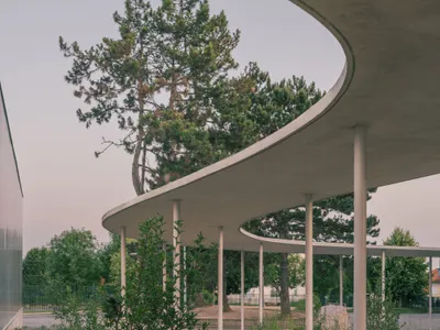 MARS Architectes Wraps a Gonesse School Cafeteria in a Curving Canopy That Shelters Trees and Children Alike