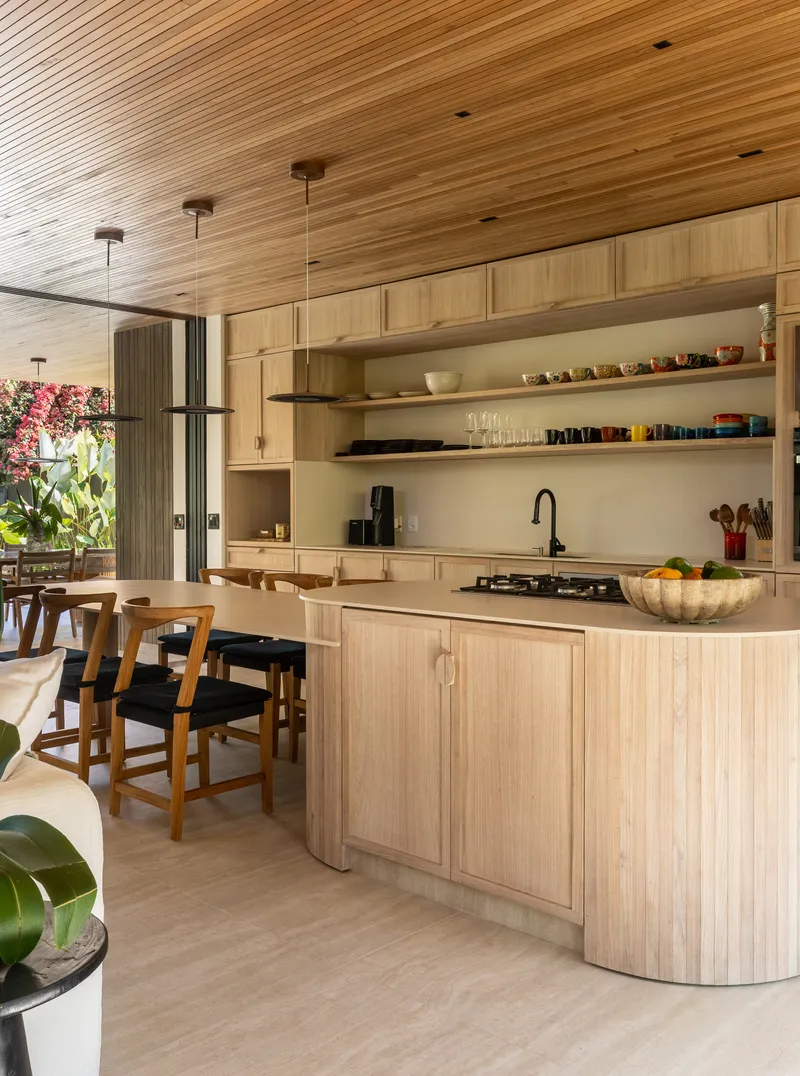 Kitchen with pale timber cabinetry and open shelving under a slatted wood ceiling