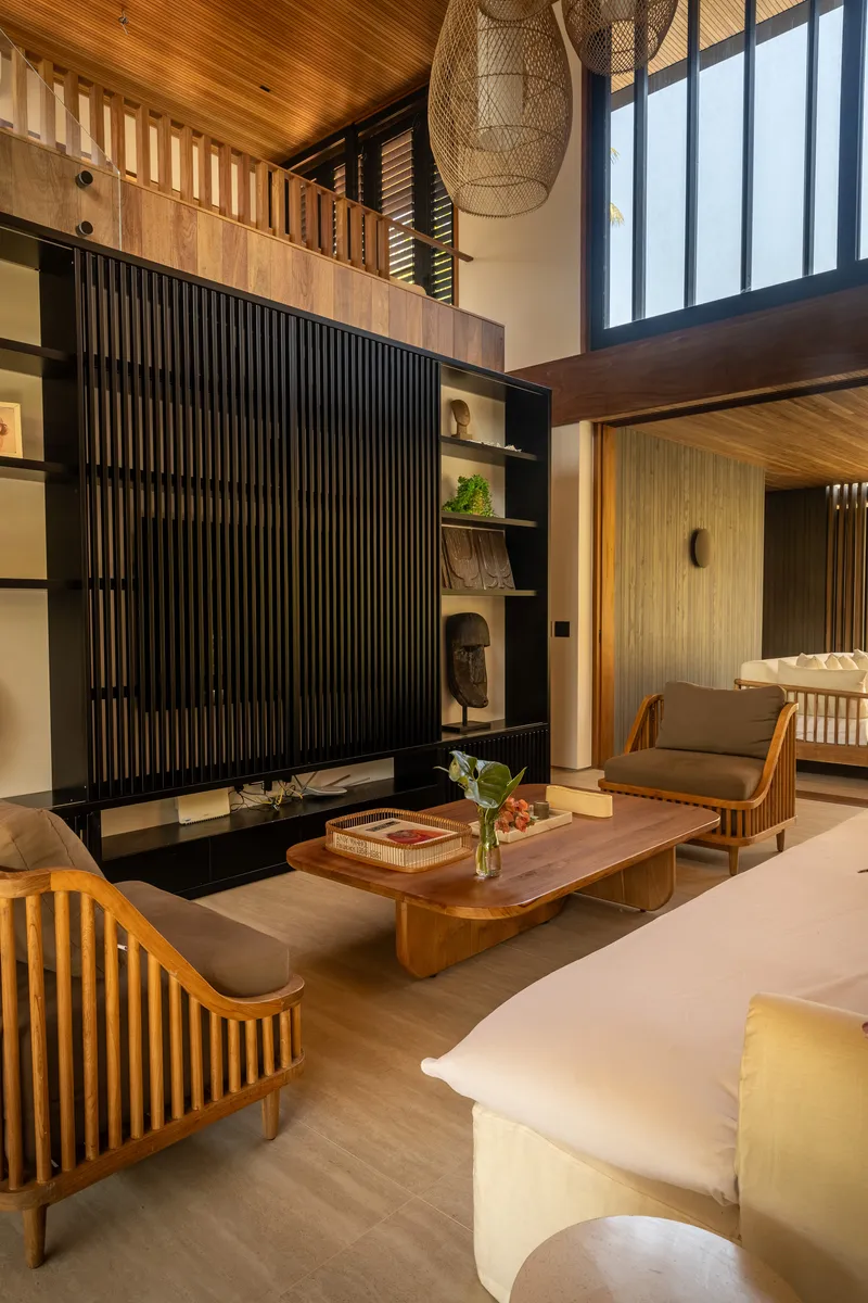 Double-height living room with slatted timber screen and mezzanine level above