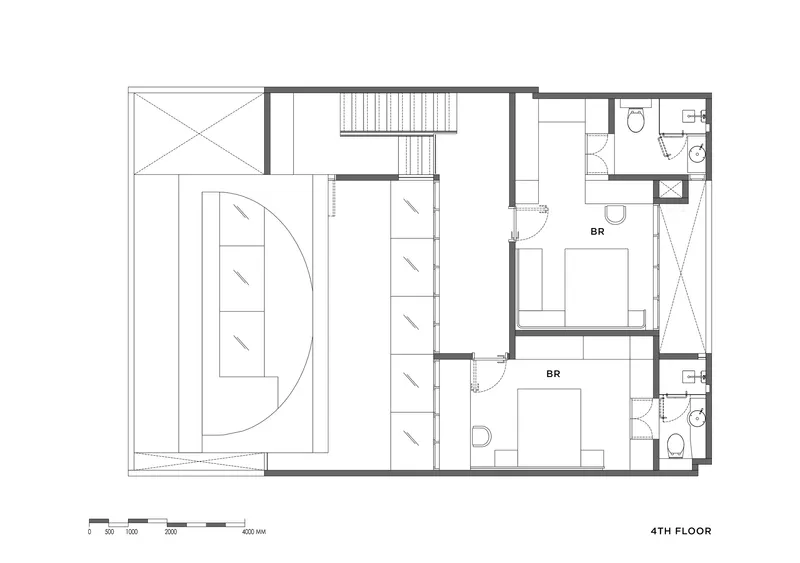 Floor plan drawing showing two bedrooms with ensuite bathrooms and a central stairwell on the fourth floor