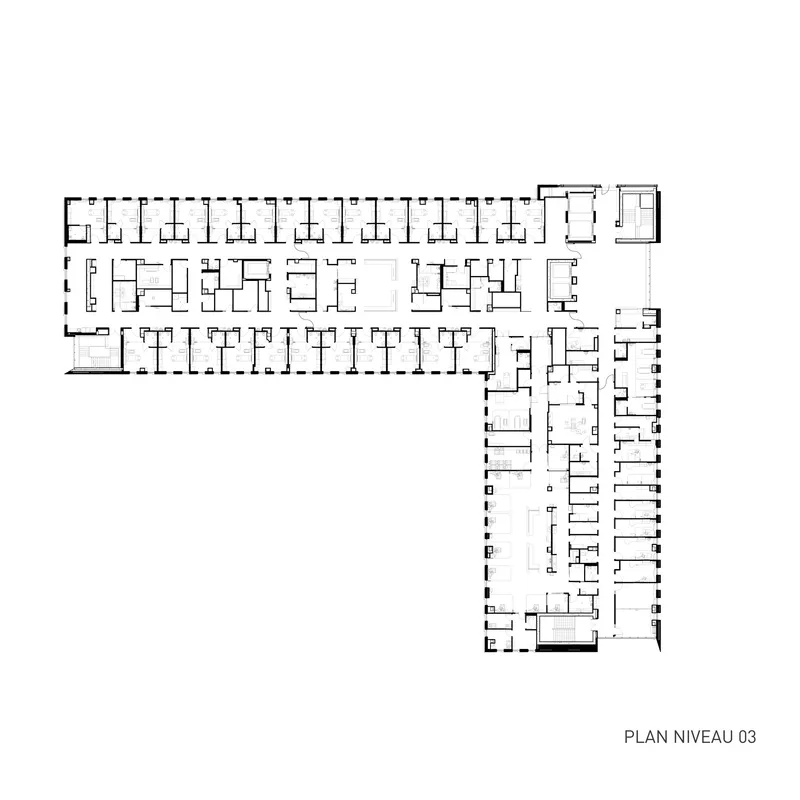 Floor plan drawing showing L-shaped arrangement with a long wing of repetitive units and perpendicular circulation bar
