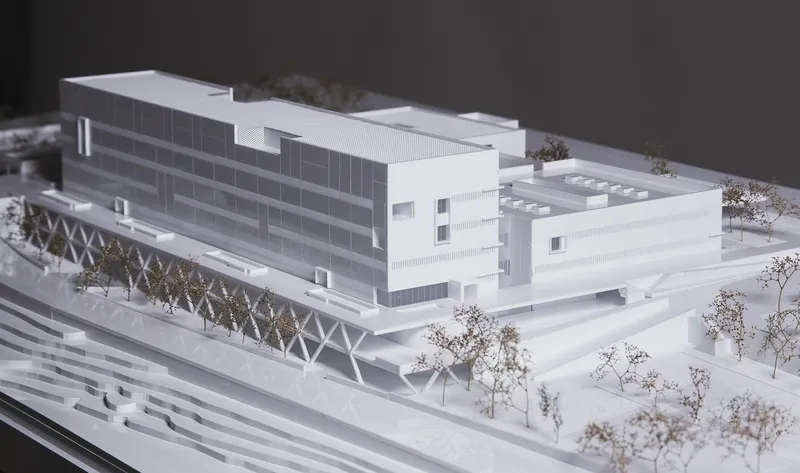 Physical model view of the multi-storey block with horizontal facade bands and diagonal truss structure beneath