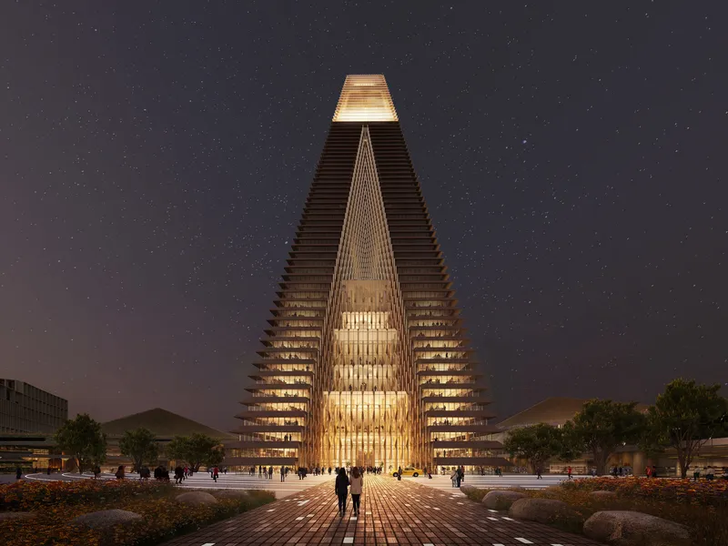 Illuminated tower entrance with triangular cutout and stacked floor plates visible under a starry night sky