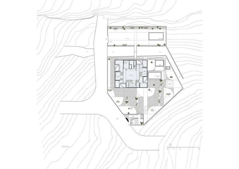 Site plan drawing showing the building footprint with courtyards and surrounding topographic contours