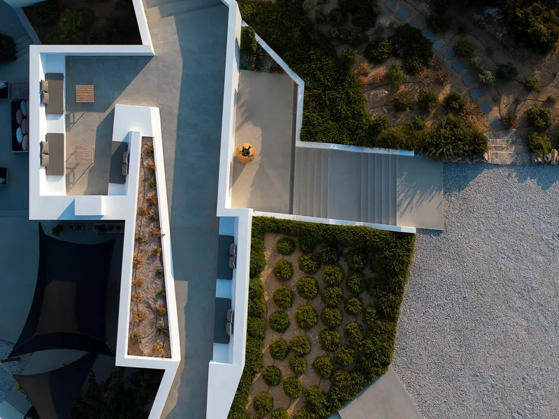 Aerial view showing the white rooftop terraces with timber decking and gravel landscaping below