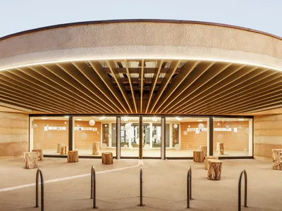 Paul Le Quernec Shapes a Cloverleaf Daycare from Rammed Earth on a Former Military Site in France