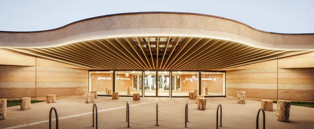 Paul Le Quernec Shapes a Cloverleaf Daycare from Rammed Earth on a Former Military Site in France