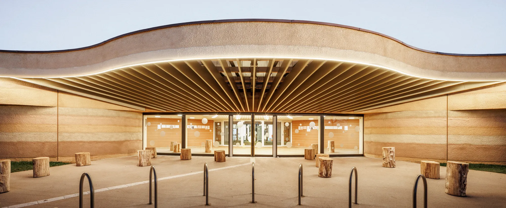 Paul Le Quernec Shapes a Cloverleaf Daycare from Rammed Earth on a Former Military Site in France