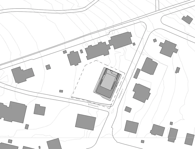 Site plan drawing showing central volume surrounded by neighboring buildings and curved street lines