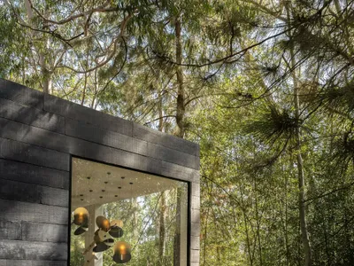Natan Gil Arquitetura Builds a Charred Timber Hotel Room as a Desert Oasis in Belo Horizonte's Forest