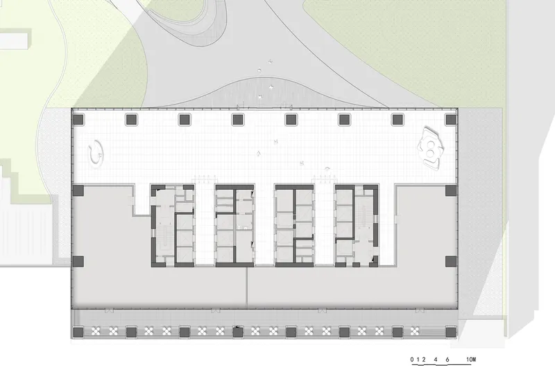 Floor plan drawing showing rectangular layout with central core and perimeter columns along landscaped edges