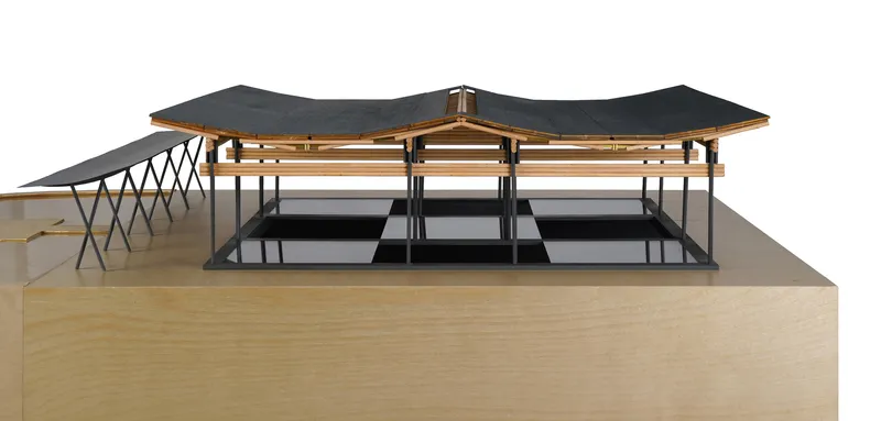 Physical model displaying the timber roof structure with dark cladding over a raised plinth base