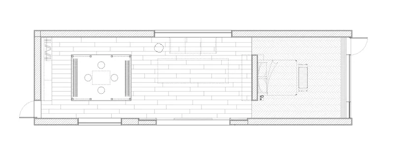 Floor plan drawing showing a long rectangular layout with kitchen, dining area and bedroom spaces