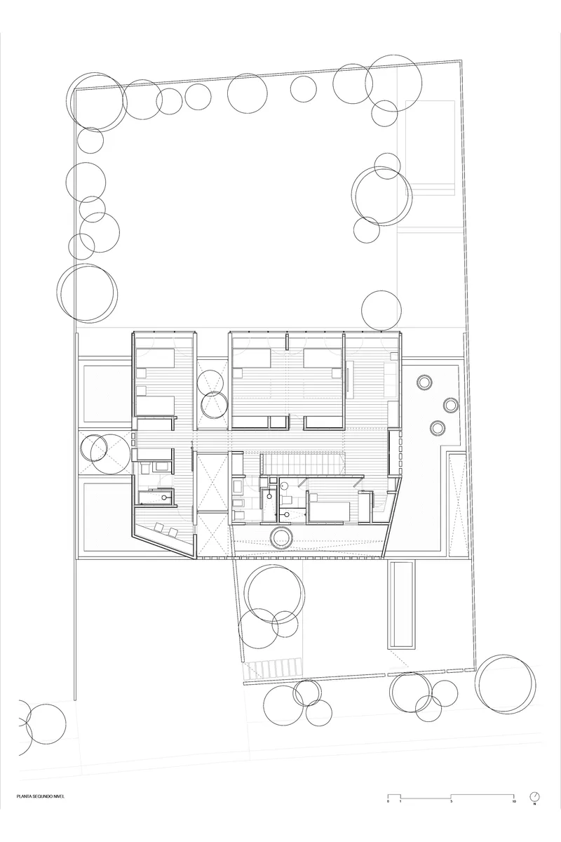 Upper floor plan drawing showing bedroom layout with central stairwell and landscaped perimeter