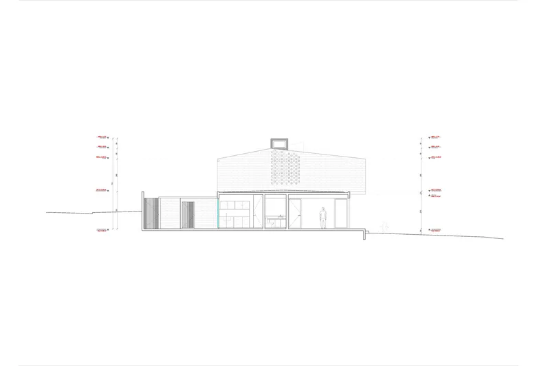 Elevation drawing showing sloped site with perforated brick volume and garage opening