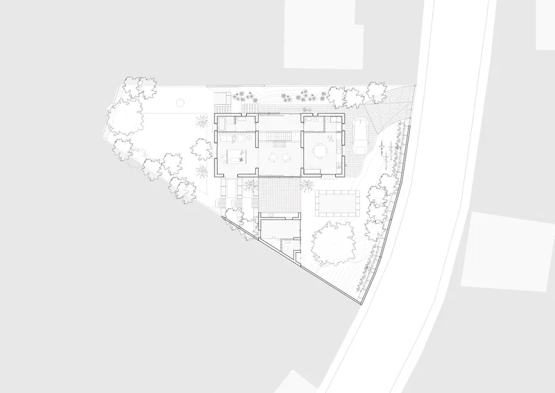 Ground floor plan drawing showing interior rooms surrounded by landscaped gardens on a triangular plot