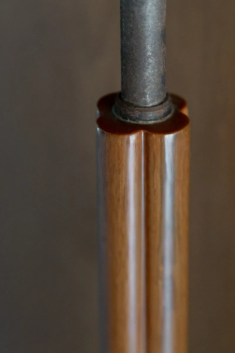 Close-up of steel pipe passing through timber sleeve with leather washer detail