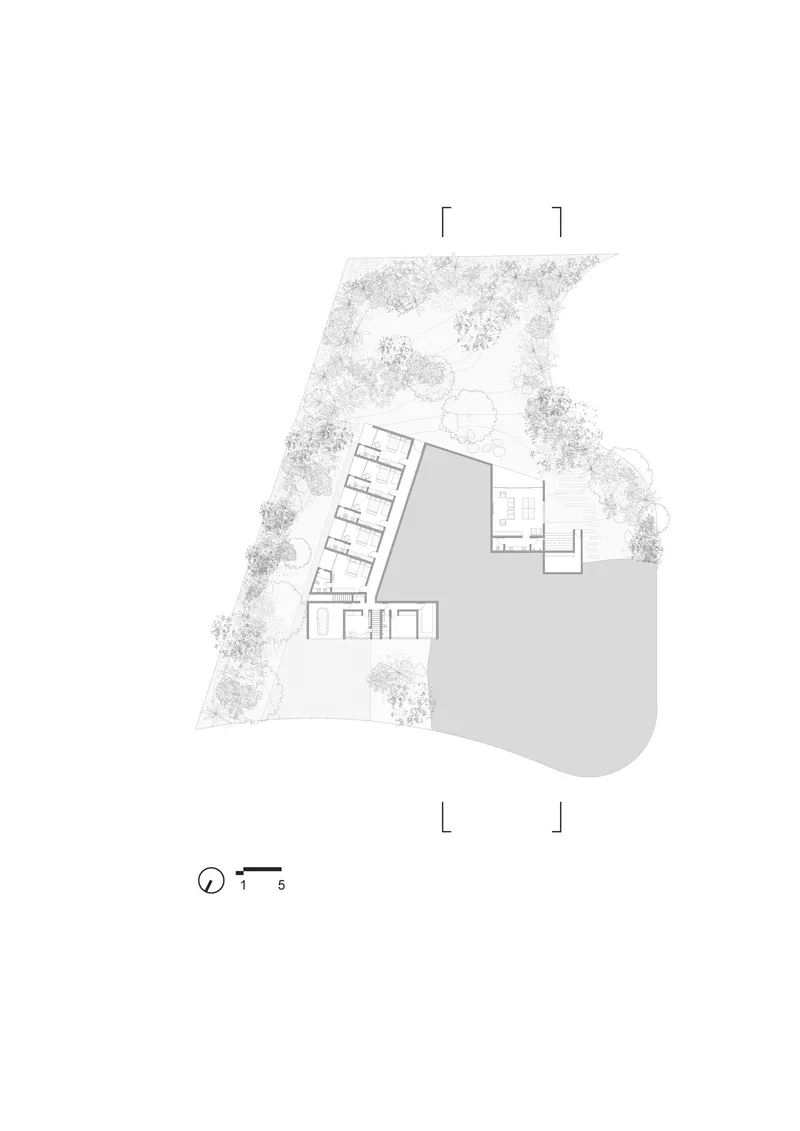 Upper floor plan drawing showing angled bedroom wing and separate pavilion with courtyard between