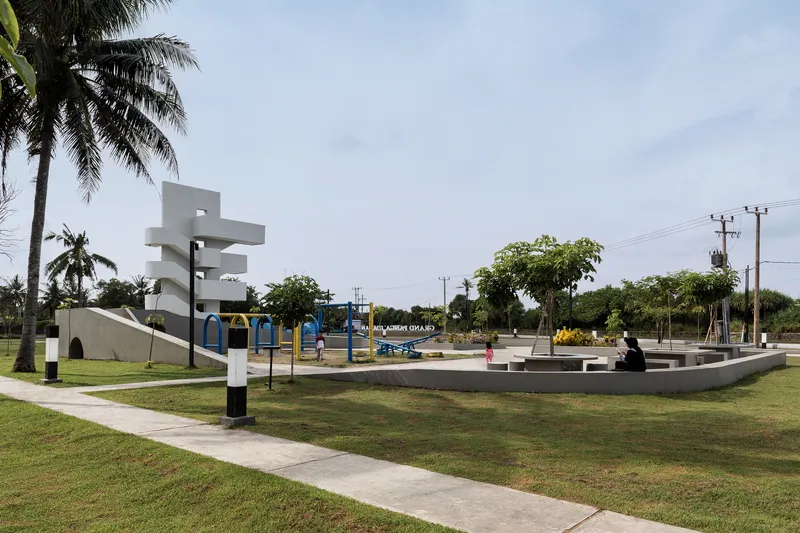 White sculptural observation tower with spiraling cantilevers overlooking the public park and playground