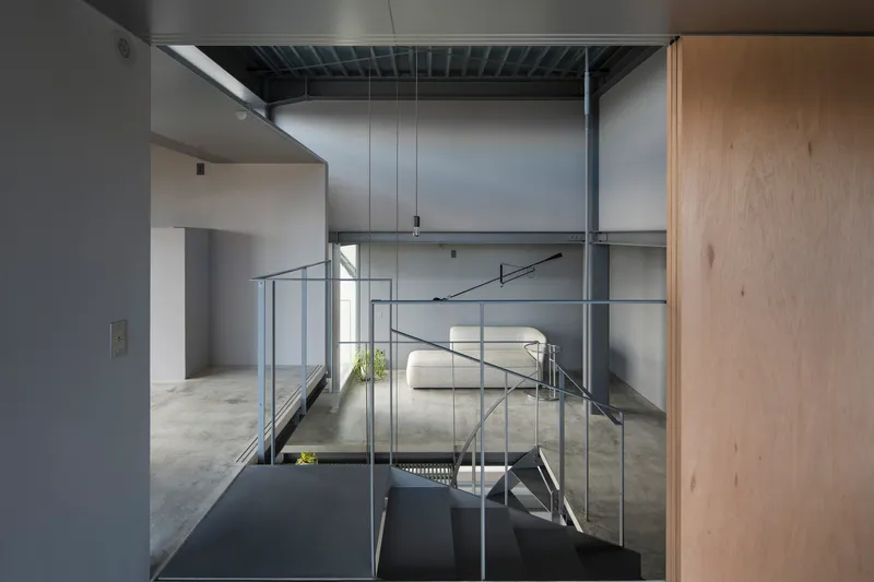 View across the upper floor with steel handrails and exposed ceiling joists in diffused daylight