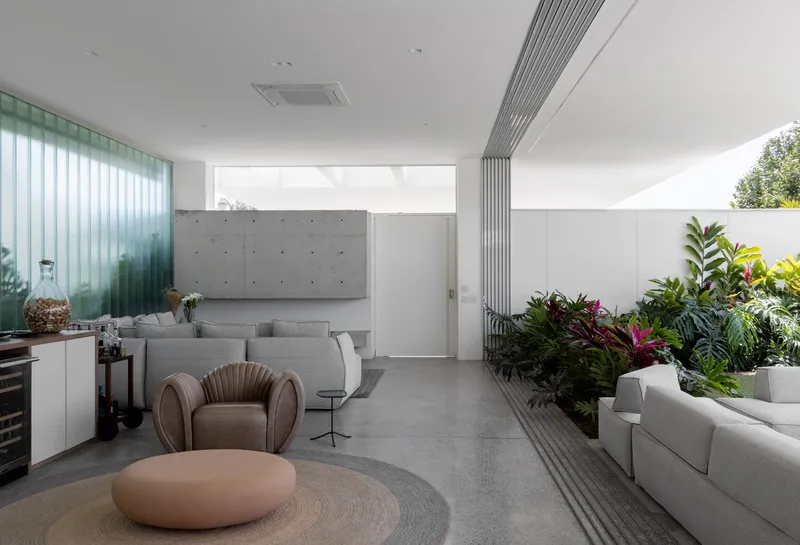 Open living space connecting to the interior garden with linear ceiling detail and polished concrete floor