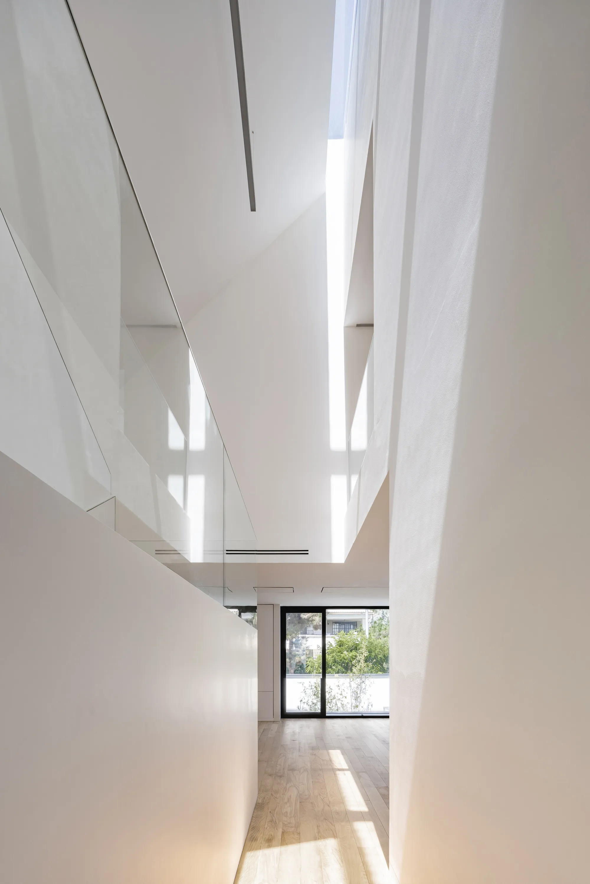 Next Office Folds a Tehran Villa into Itself, Turning Pitched Roofs into Vertical Light Wells