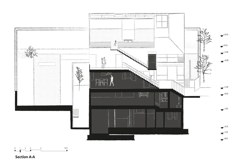 Section drawing illustrating split-level arrangement with diagonal staircase connecting ground and upper floors