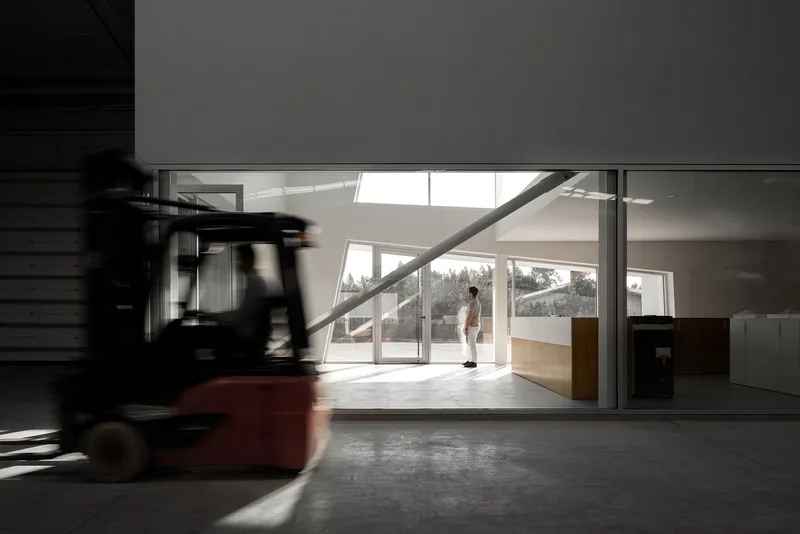 Industrial interior juxtaposed with soft daylight and clean architectural lines.
