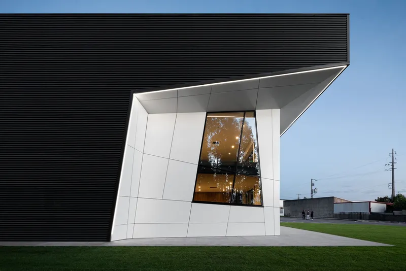 Precision detailing at the junction of metal cladding and glass façade.