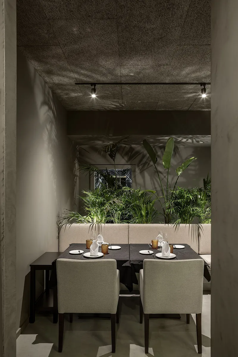 A restrained palette and open frontage connect the interior seamlessly with the urban context.