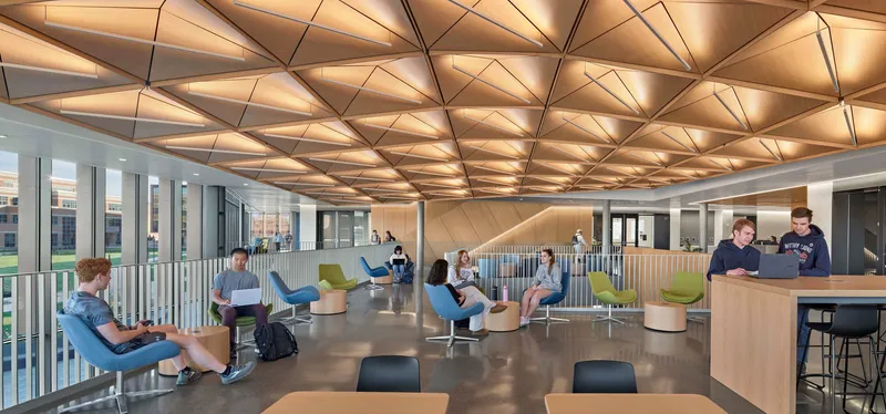 Upper-level lounge space with faceted acoustic wood ceiling and students in casual seating
