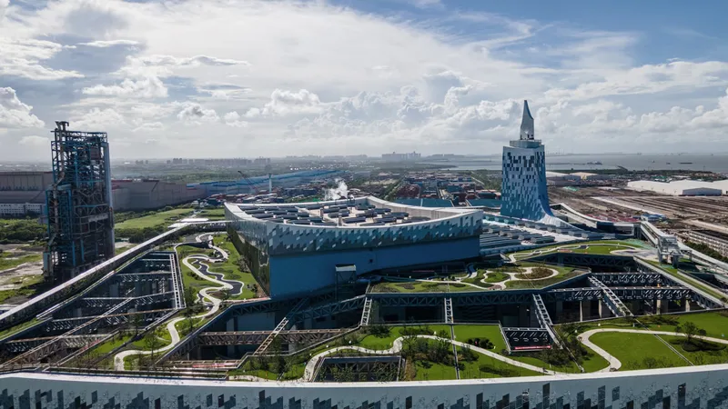 Elevated view showing the landscaped roof gardens and pathways between the tapered towers under cloudy skies