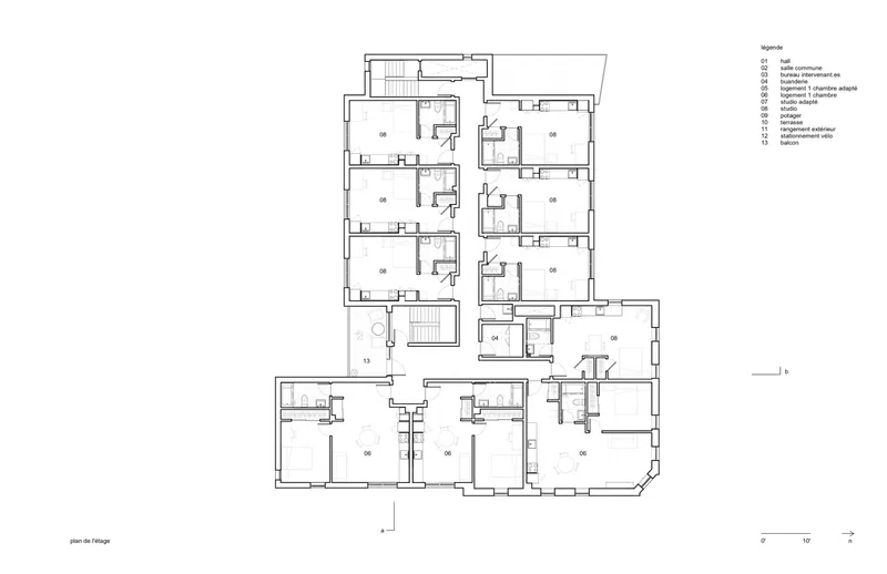Upper floor plan drawing showing residential units with private bathrooms and shared circulation spaces