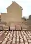 This architectural image showcases a brick building facade with a gable roof, complemented by stacks