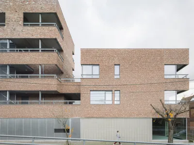 MAKER Architecten Weaves Social Housing into Kortrijk's Dense Urban Fabric with Brick and Restraint