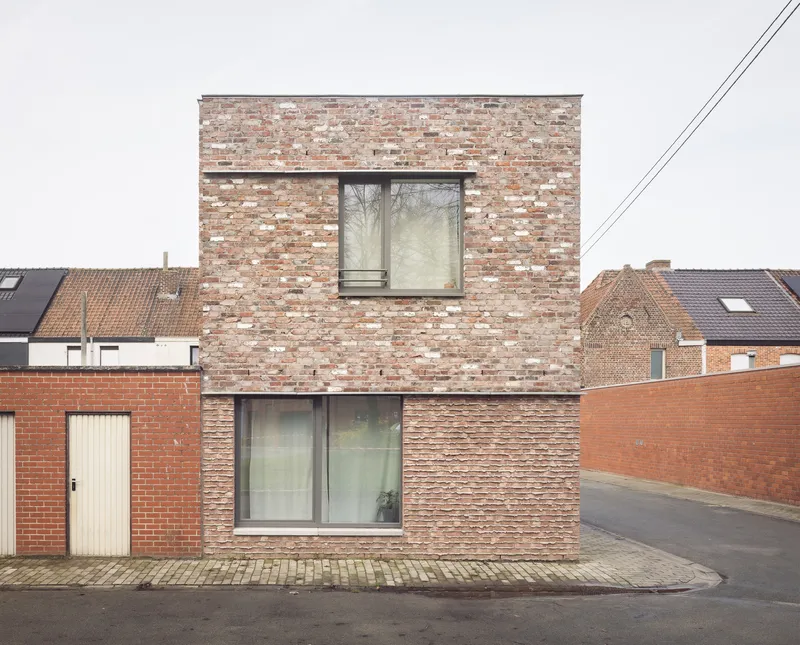 Rear facade showing mixed brick coursing with two large glazed openings facing a residential street