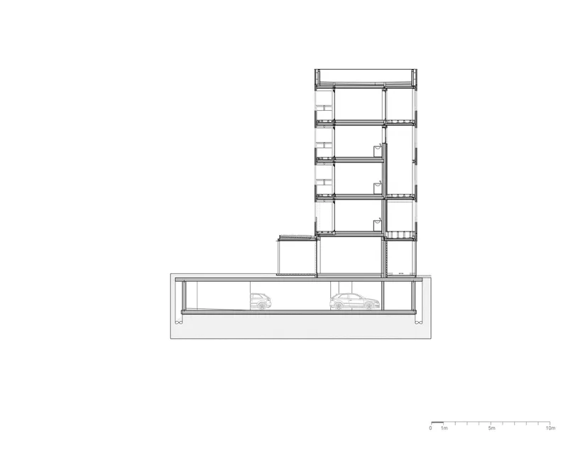 Building section showing a five-story tower above a sunken basement level with parked vehicles