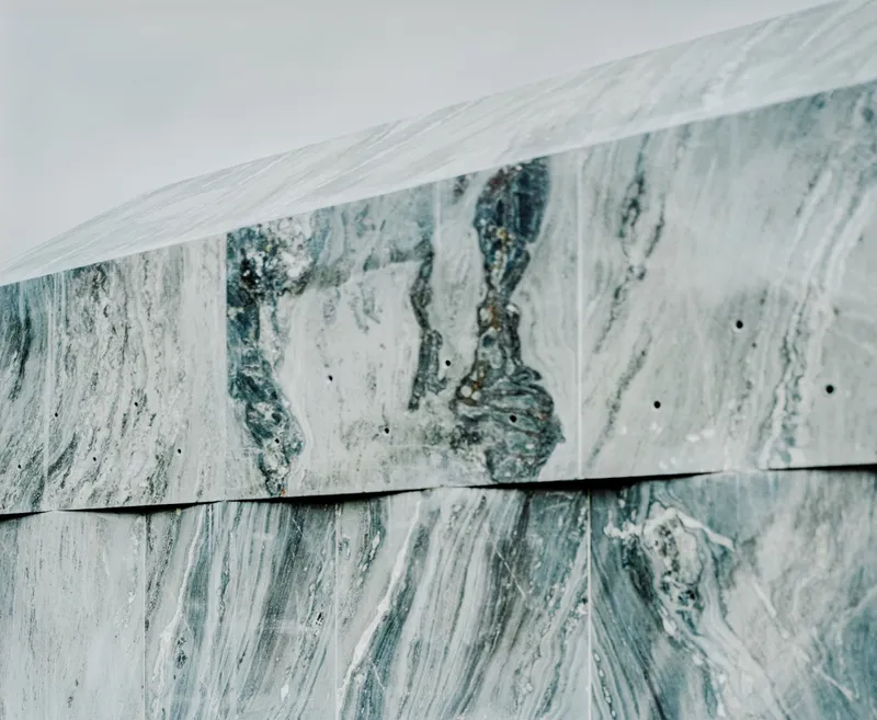 Close-up of the green and white marble panel joint with visible veining patterns