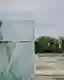This architectural image captures a cemetery scene, juxtaposing a green marble structure with rows o