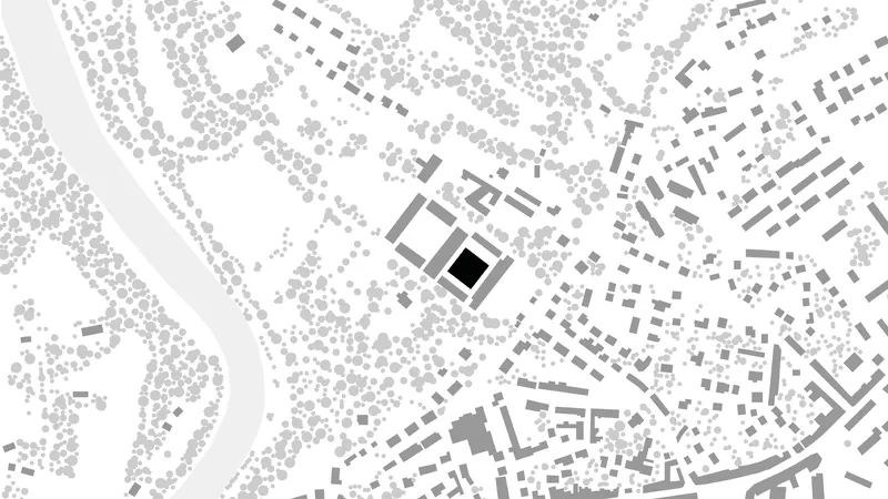 Site plan drawing showing a square building footprint surrounded by irregular urban fabric