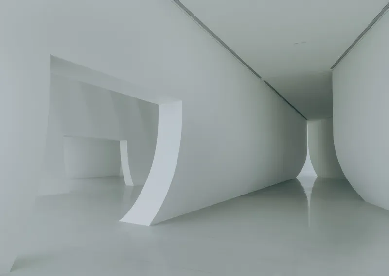 Close-up of the curved white wall meeting the polished floor in the gallery space
