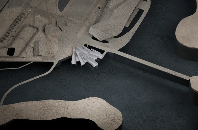 Aerial view of a physical model with angular white roof forms nestled between sculptural earthwork berms