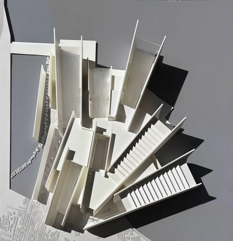 Axonometric sectional model exposing vertical circulation, staircases, and spatial layering between floor plates
