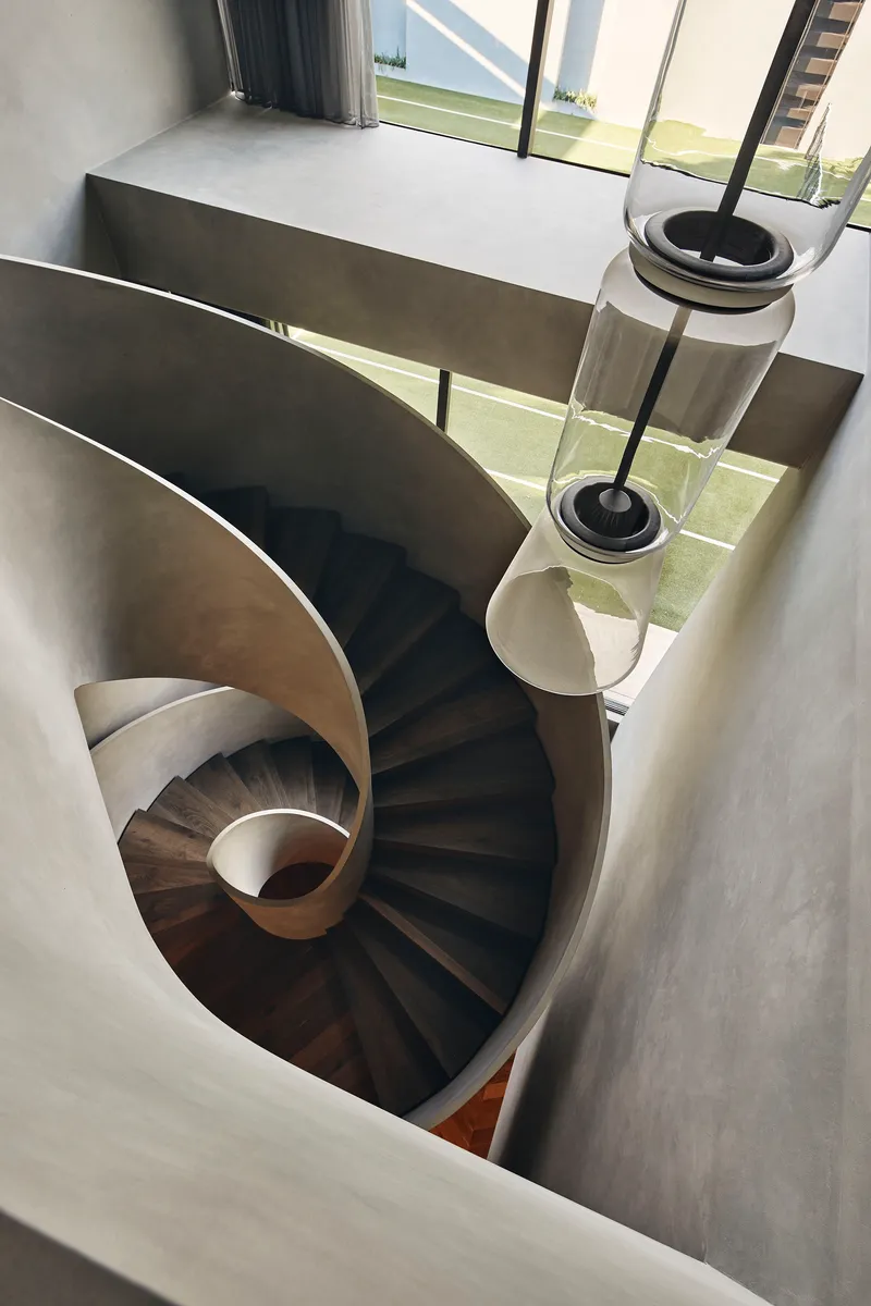 Top-down view of spiral staircase with dark timber treads and white balustrade