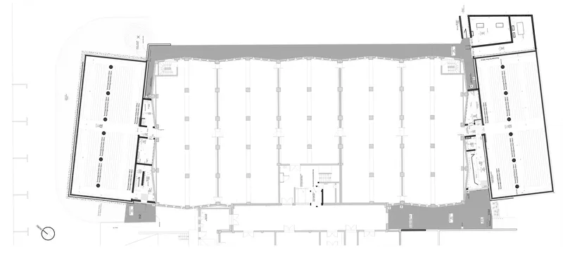 Floor plan drawing of sawtooth-roofed hall with grid of columns and side circulation zones