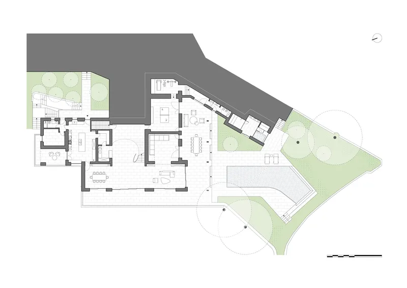 Ground floor plan drawing showing interconnected rooms with surrounding landscaped gardens and trees