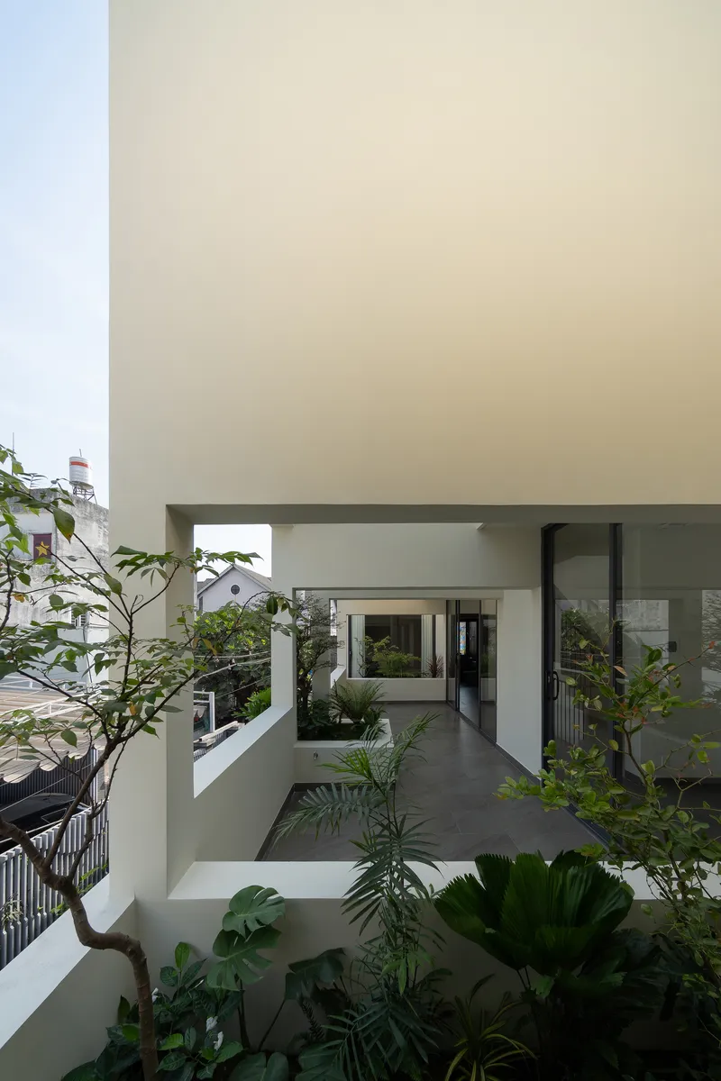 Interior courtyard with white walls and terraced planters surrounding the upper levels