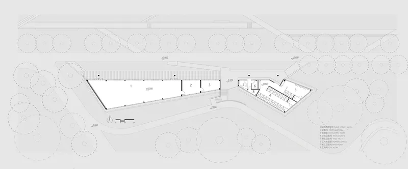Floor plan drawing showing two angled wings with interior rooms surrounded by landscaping